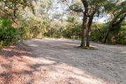 Electric hookup, picnic table and fire ring nestled under live oak trees and shady maritime hammock on site 27âs sandy pad in Anastasia State Park.