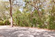 Side view of paved site 133 showing electric and water hookups with live oak trees nestled under shady maritime hammock in Anastasia State Park.