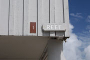 Photo: 001, Brown number plate with white number and the name Reef in white letters, on grey cabin,