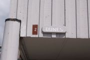 Photo: 002, Brown number plate with white number and the name Dunes in white letters, on grey cabin.