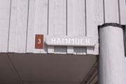 Photo: 003, Brown number plate with white number and the name Hammock in white letters, on grey cabin.