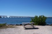 Photo: Buttonwood: Gravel, bushes, picnic table, water and old Bahia Honda Bridge in the background.