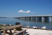 Photo: Buttonwood: Gravel site, picnic table and grill, water and new and old Bahia Honda Bridge in the background.