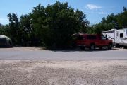 Photo: Buttonwood: Paved road with 2 occupied sites in background and bushes around sites