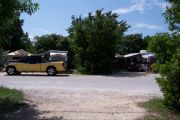 Photo: Buttonwood: Paved road with two occupied sites in background and bushes around sites