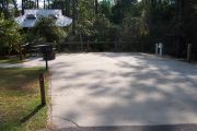 Shady RV/Trailer site with concrete pad for ADA accessibility.