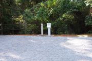 View from the side of the partially shaded campsite with hookups.