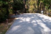 A view of the campsite with a shell/sand base and mostly shade.