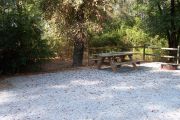 View of a picnic table and fire ring.
