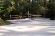 View of a picnic table in partial shade.