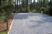 A view of the campsite with a shell/sand/grass base in shade.