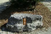 Photo: 015, JOHN PENNEKAMP CORAL REEF SP. Rock with white campsite number and white arrows pointing to site on brown metal plate.