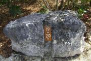 Photo: 020, JOHN PENNEKAMP CORAL REEF SP. Rock with white campsite number and white arrows pointing to site on brown metal plate.