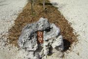 Photo: 027, JOHN PENNEKAMP CORAL REEF SP. Rock with white campsite number and white arrows pointing to site on brown metal plate.