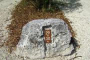 Photo: 029, JOHN PENNEKAMP CORAL REEF SP. Rock with white campsite number and white arrows pointing to site on brown metal plate.