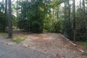 Campsite with picnic table and ground grill.