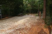Deep campsite with picnic table and ground grill.