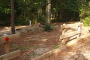 Campsite with water, electric, picnic table and ground grill.