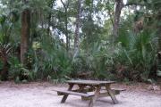 This view shows an up close view of the picnic table on the campsite.