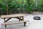 This view shows an up close view of the picnic table on the campsite.