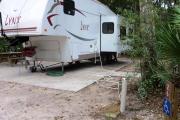 Each site is equipped with a picnic table, clothesline/lantern post, hose bib, electric hook-up for 20 and 50 amp service, and fire pit on the ground with a fold over grill top.