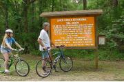 Bicyclists pause to study the informational kiosk before starting out on one of the trails that comprise the parkâs 6.5 miles of trails. The multiuse trails are enjoyed by hikers, joggers, bicyclists and horseback riders.