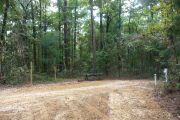 Campsite with picnic table and ground grill.