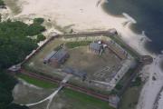 An aerial view of Fort Clinch showing the rooftops of each building, the large parade ground and the perfect pentagon formed by the strong, straight and thick brick walls.