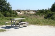 Picture of campsite amenities including campfire ring and picnic table