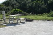 Picture of campsite amenities including campfire ring and picnic table