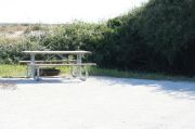 Picture of campsite amenities including campfire ring and picnic table