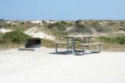 Picture of campsite amenities including campfire ring and picnic table