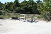 Picture of campsite amenities including campfire ring and picnic table