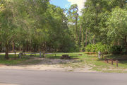 Partially shaded campsite with a picnic table.