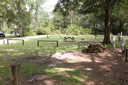 Shaded campsite with a picnic table, located in the middle of the campground.