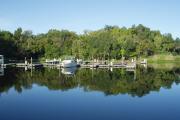 Silhouette of a visitor in a shady spot enjoying fishing the St Johns River