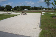 Photo: 003, Campsite with picnic table, grill and fire ring on the left and water and electric on the left.