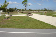 Photo: 003, Campsite with picnic table, grill and fire ring on the left and water and electric on the left.