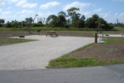 Photo: 008, Campsite with picnic table, grill and fire ring on the left and water and electric on the left.