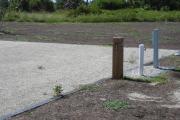 Site number next to water and electric hookups at the back of the site.