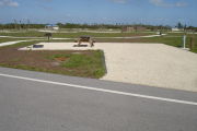 Photo: 012, Campsite with picnic table, grill and fire ring on the left and water and electric on the left.