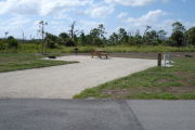 Photo: 013, Campsite with picnic table, grill and fire ring on the left and water and electric on the left.