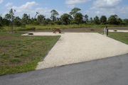 Photo: 013, Campsite with picnic table, grill and fire ring on the left and water and electric on the left.