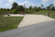 Photo: 014, Campsite with picnic table, grill and fire ring on the left and water and electric on the left.