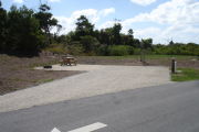 Photo: 020, Back in site. Campsite with picnic table, grill and fire ring on the left and water and electric on the left.