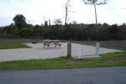 Photo: 024, Campsite with picnic table, grill and fire ring on the left and water and electric on the left.