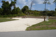 Photo: 025, Campsite with picnic table, grill and fire ring on the left and water and electric on the left.