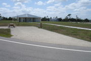 Photo: 026, Campsite with picnic table, grill and fire ring on the left and water and electric on the left.