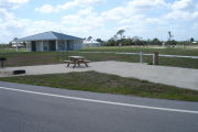 Photo: 026, Campsite with picnic table, grill and fire ring on the left and water and electric on the left.