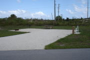 Photo: 028, Campsite with picnic table, grill and fire ring on the left and water and electric on the left.
